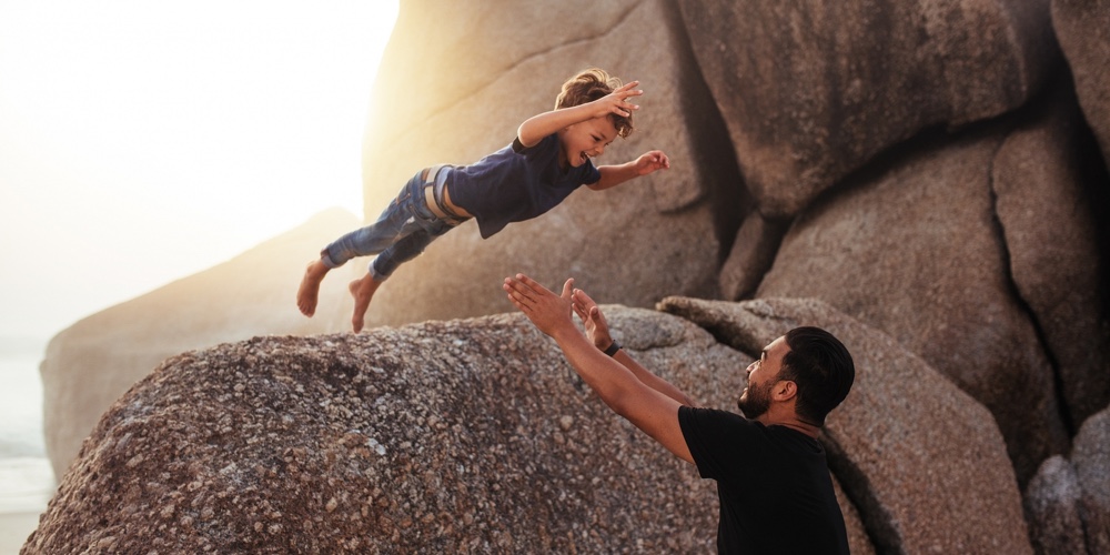 Father And Son Enjoying Summer Holidays At The Beach